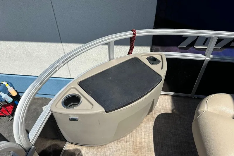 Slide: The Image of 2022 Sun Tracker Bass Buggy 18 DLX boat interior with storage and cup holders. - 32