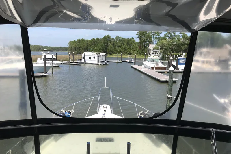 Slide: The Image of View from 1988 Tollycraft 40 Sundeck Motor Yacht in marina, surrounded by boats and trees. - 10