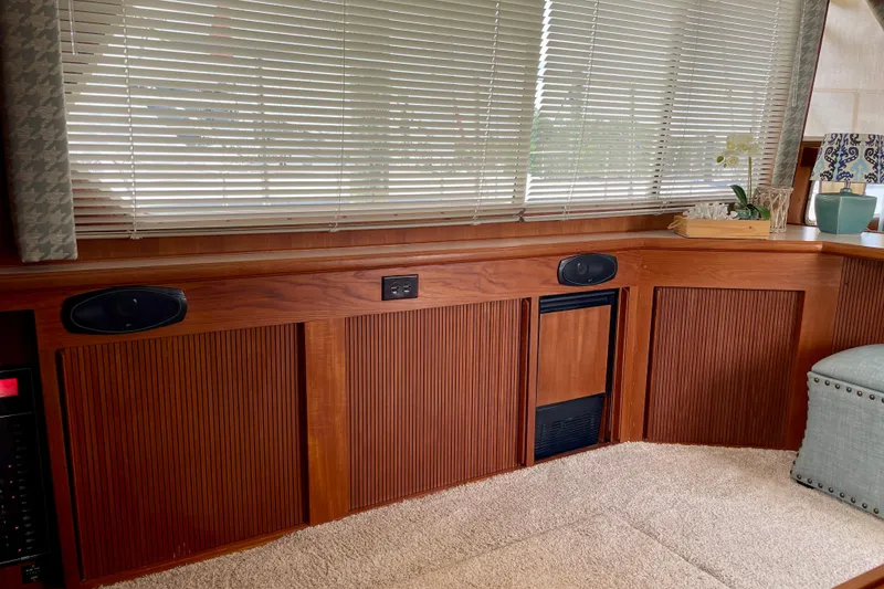 Slide: The Image of 1988 Tollycraft 40 Sundeck Motor Yacht interior with wood paneling and blinds. - 16
