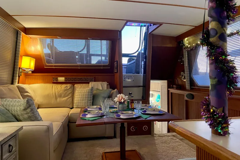 Slide: The Image of Interior of 1988 Tollycraft 40 Sundeck Motor Yacht, featuring cozy seating and festive decor. - 17