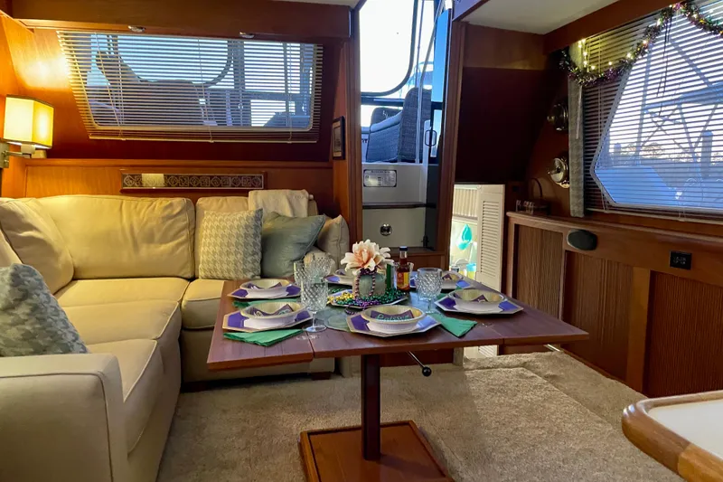 Slide: The Image of Interior of 1988 Tollycraft 40 Sundeck Motor Yacht with cozy dining setup. - 18