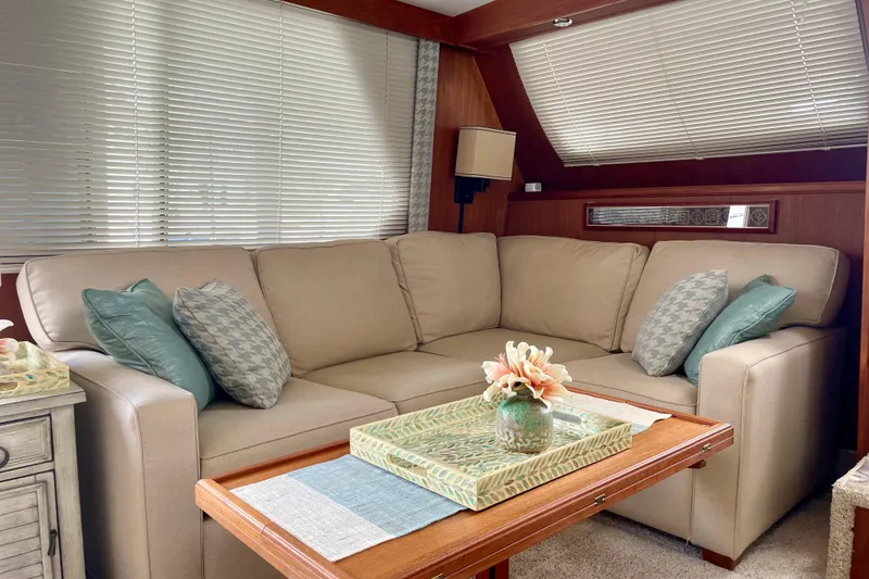 Slide: The Image of Luxurious interior of 1988 Tollycraft 40 Sundeck Motor Yacht with beige sofa and decorative pillows. - 21