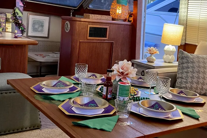 Slide: The Image of Elegant dining setup inside 1988 Tollycraft 40 Sundeck Motor Yacht, featuring decorative tableware and ambient lighting. - 24