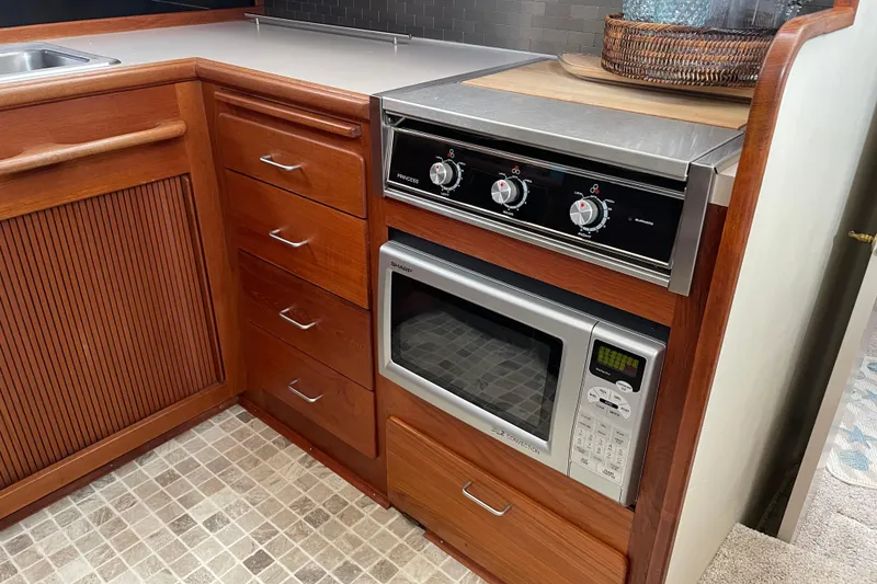 Slide: The Image of 1988 Tollycraft 40 Sundeck Motor Yacht kitchen with stove and microwave. - 27