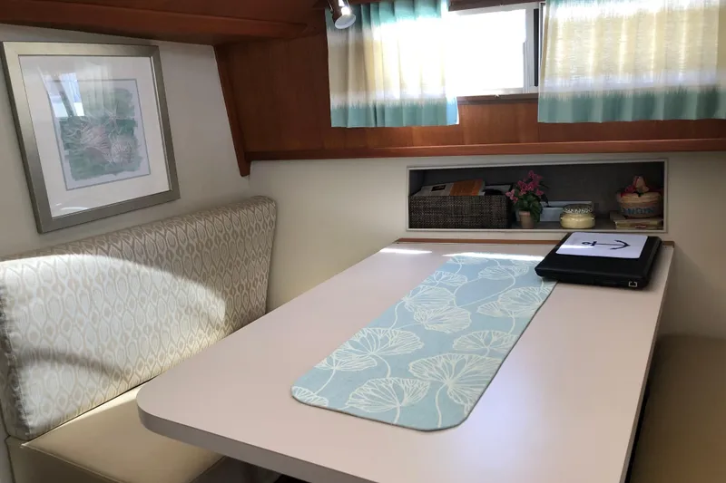 Slide: The Image of Cozy dining area in 1988 Tollycraft 40 Sundeck Motor Yacht with elegant decor. - 28