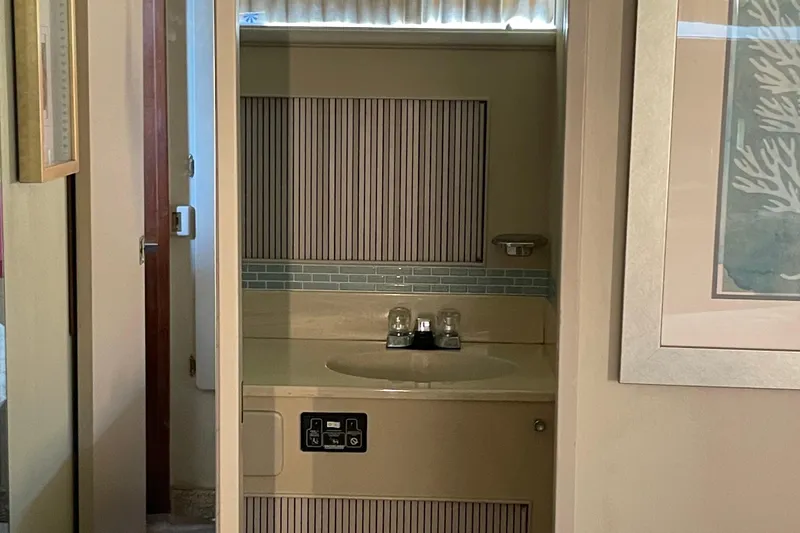Slide: The Image of 1988 Tollycraft 40 Sundeck Motor Yacht bathroom with sink and mirror. - 35