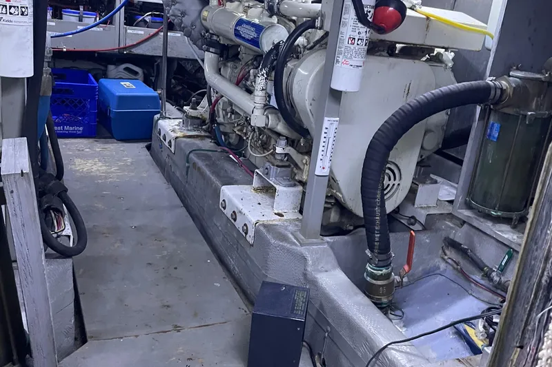 Slide: The Image of Engine room of 1988 Tollycraft 40 Sundeck Motor Yacht with visible machinery and equipment. - 46