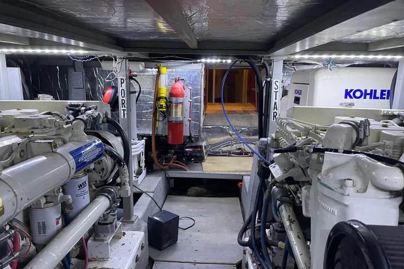 Slide: The Image of Engine room of 1988 Tollycraft 40 Sundeck Motor Yacht with visible machinery and equipment. - 49