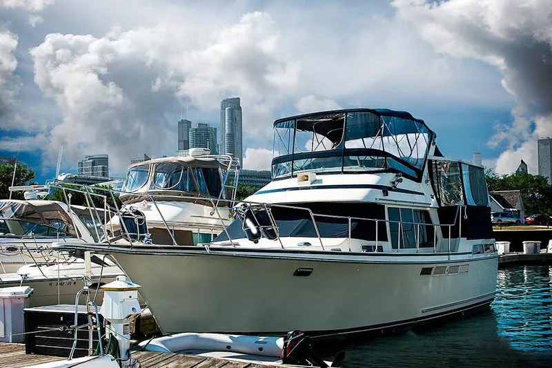 Slide: The Image of 1988 Tollycraft 40 Sundeck Motor Yacht docked with city skyline backdrop. - 5