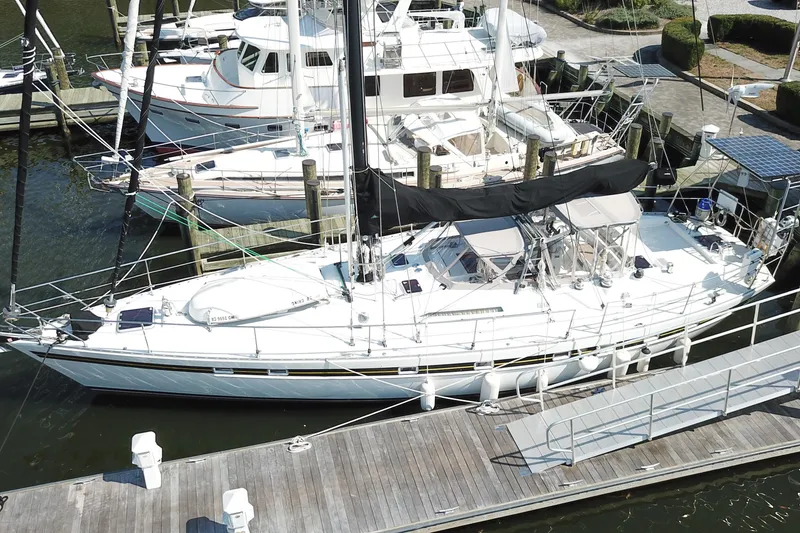 The Image of 1984 Tayana 55 sailboat docked at a marina, viewed from above. - 0