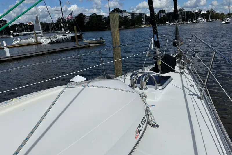 Slide: The Image of 1984 Tayana 55 sailboat docked at a marina with clear skies and calm waters. - 10