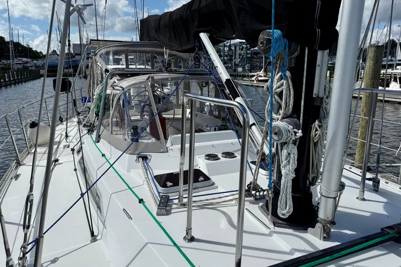 Slide: The Image of 1984 Tayana 55 sailboat deck with rigging and marina background. - 12