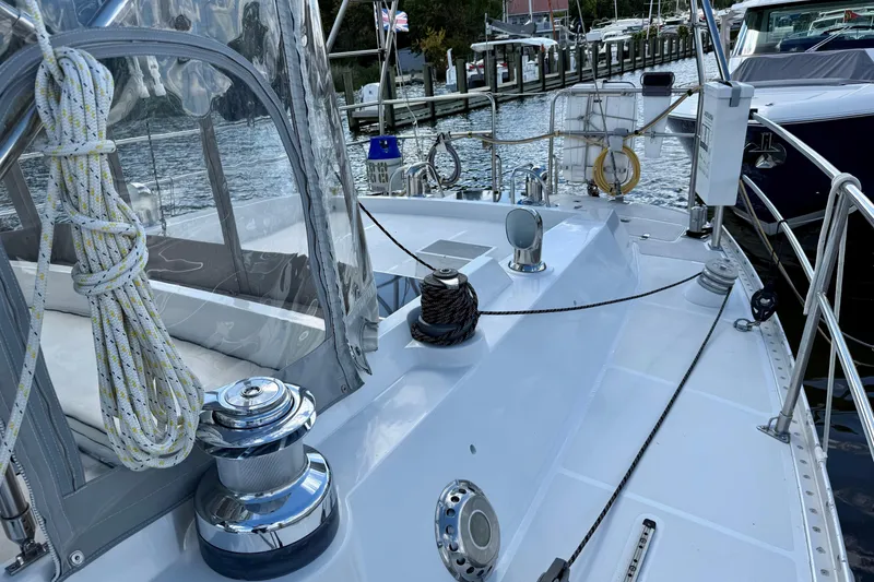 Slide: The Image of 1984 Tayana 55 sailboat deck with winches and ropes, docked at a marina. - 22