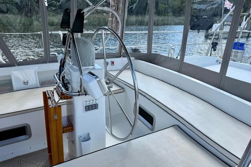 Slide: The Image of Cockpit of 1984 Tayana 55 sailboat with steering wheel and seating. - 23