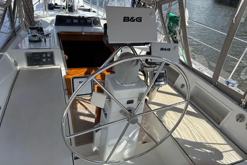 Slide: The Image of Cockpit of 1984 Tayana 55 sailboat with steering wheel and navigation equipment. - 24