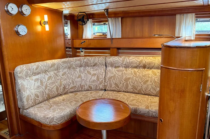 Slide: The Image of Cozy interior of 1984 Tayana 55 yacht with elegant wood finish and patterned seating. - 37