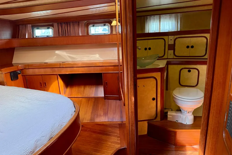 Slide: The Image of Interior of 1984 Tayana 55 yacht with wooden furnishings and compact bathroom. - 40