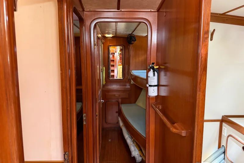 Slide: The Image of Interior of 1984 Tayana 55 yacht with wooden paneling and cozy cabin space. - 41