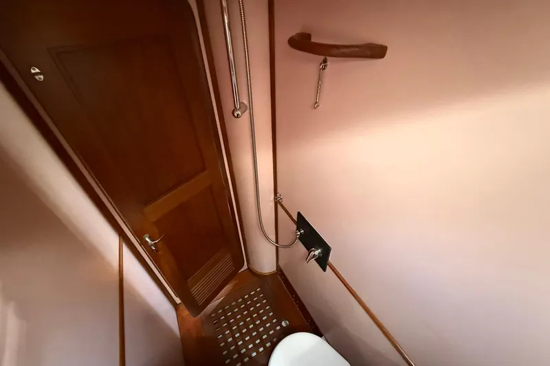 Slide: The Image of Bathroom interior of 1984 Tayana 55 yacht with wooden door and shower area. - 47