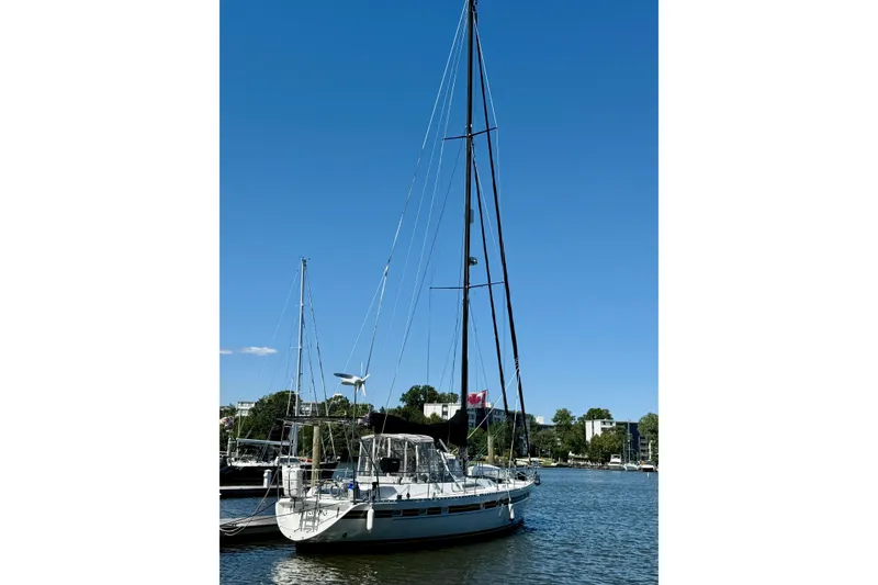 Slide: The Image of 1984 Tayana 55 sailboat docked on a sunny day with clear blue sky. - 9