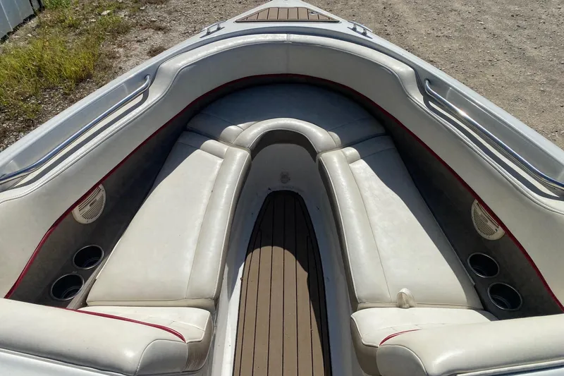 Slide: The Image of 2004 Crownline 250 CR boat interior with cushioned seating and cup holders. - 12