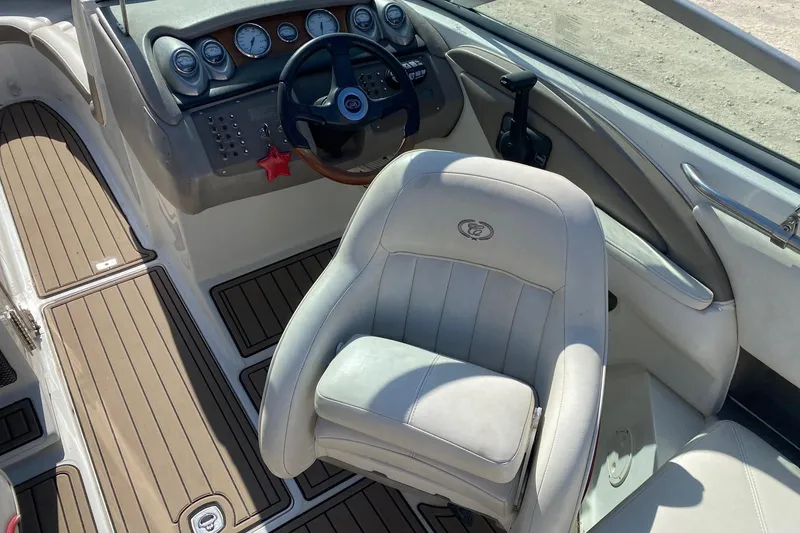 Slide: The Image of 2004 Crownline 250 CR boat interior with steering wheel and control panel. - 14