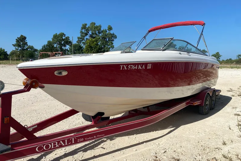 Slide: The Image of 2004 Crownline 250 CR boat on trailer, red and white design, parked outdoors. - 6