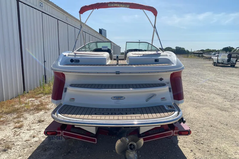 Slide: The Image of 2004 Crownline 250 CR boat, rear view, parked outdoors on a sunny day. - 8