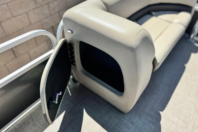 Slide: The Image of 2023 Sun Tracker Party Barge 18 DLX storage compartment with open hatch and seating. - 11