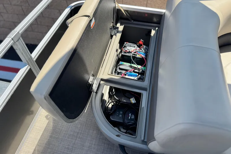 Slide: The Image of 2023 Sun Tracker Party Barge 18 DLX storage compartment with batteries and wiring. - 17