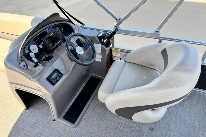 Slide: The Image of 2023 Sun Tracker Party Barge 18 DLX helm with steering wheel and captain's chair. - 20
