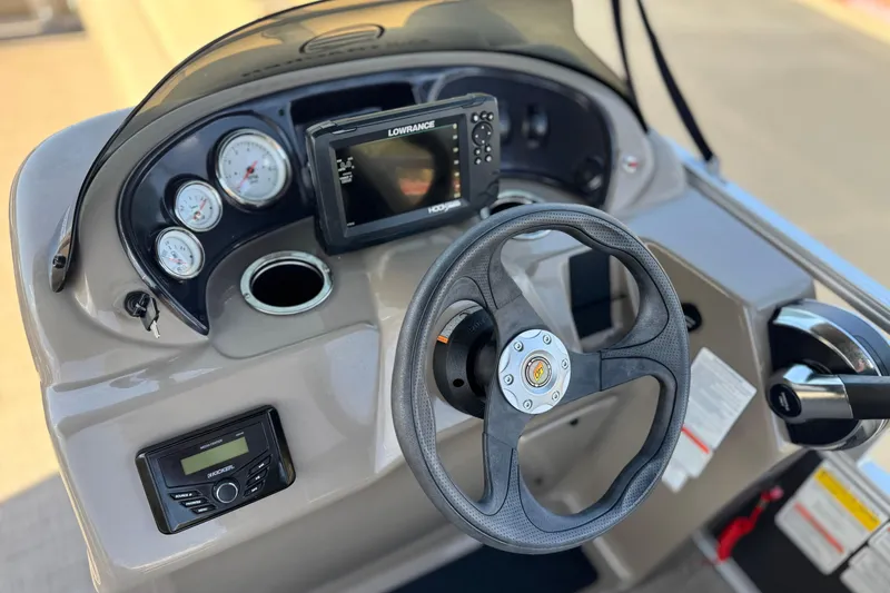 Slide: The Image of 2023 Sun Tracker Party Barge 18 DLX dashboard with steering wheel and navigation system. - 22