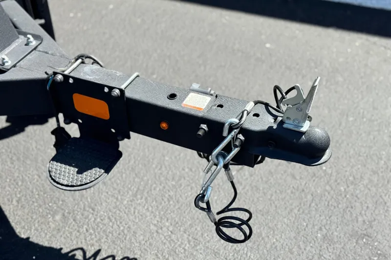 Slide: The Image of Trailer hitch of 2023 Sun Tracker Party Barge 18 DLX on asphalt surface. - 24