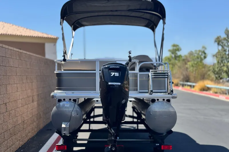 Slide: The Image of 2023 Sun Tracker Party Barge 18 DLX pontoon boat with Mercury 75 engine, rear view. - 5