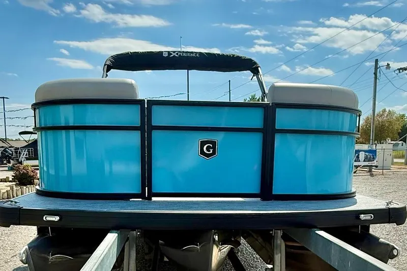 Slide: The Image of 2026 Godfrey Xperience EX2086SFLX pontoon boat with blue exterior, docked under a sunny sky. - 3