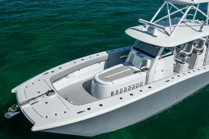 Slide: The Image of 2024 Freeman 43 boat on clear water, showcasing sleek design and spacious deck. - 12