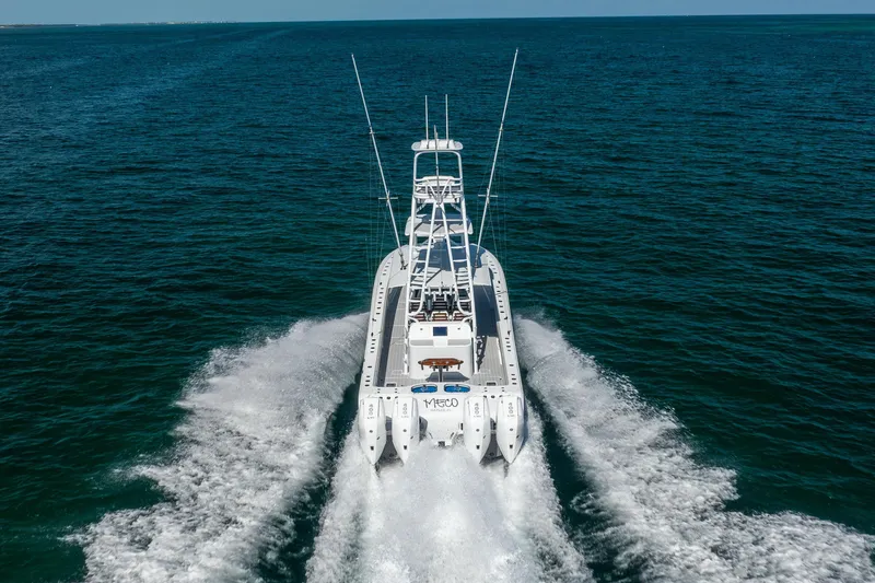 Slide: The Image of 2024 Freeman 43 boat cruising on open ocean waters, rear view. - 15