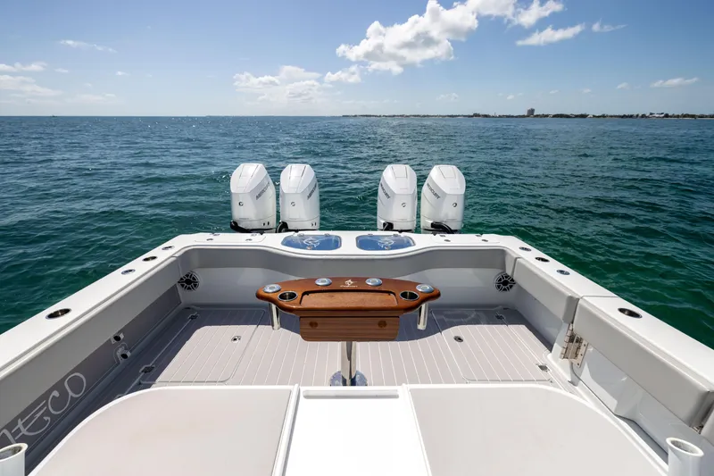 Slide: The Image of 2024 Freeman 43 boat with four outboard motors on open water. - 23