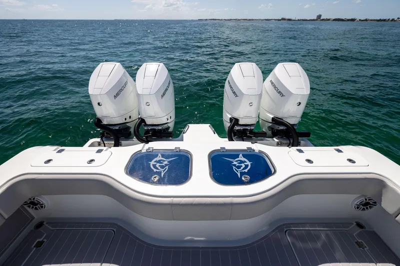 Slide: The Image of 2024 Freeman 43 boat with four Mercury outboard engines on open water. - 24