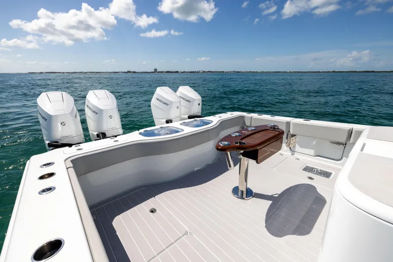 Slide: The Image of 2024 Freeman 43 boat deck with four Mercury outboard engines on open water. - 25
