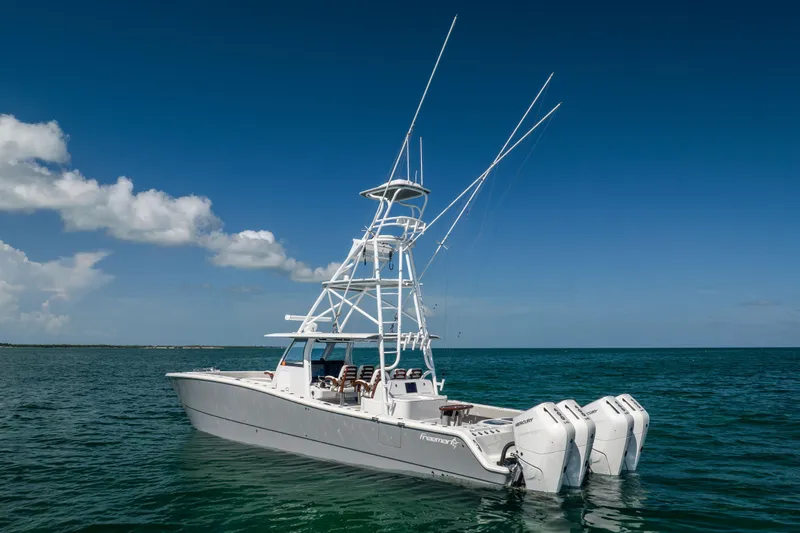 Slide: The Image of 2024 Freeman 43 boat with multiple outboard engines on open water. - 3