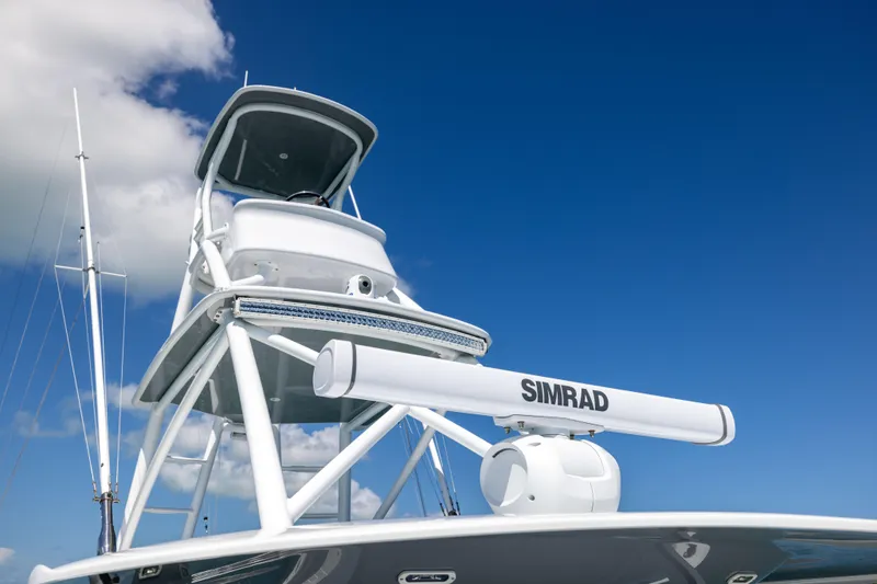 Slide: The Image of 2024 Freeman 43 boat with Simrad radar against clear blue sky. - 38