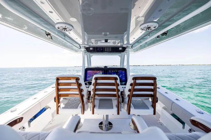 Slide: The Image of 2024 Freeman 43 boat interior with helm, ocean view, and modern seating. - 40