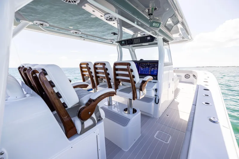 Slide: The Image of 2024 Freeman 43 boat interior with sleek seating and advanced navigation system on open water. - 42