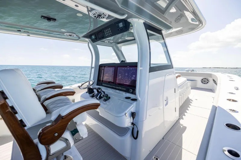 Slide: The Image of Luxury Freeman 43 boat interior, 2024 model, featuring advanced navigation systems and plush seating on open water. - 45