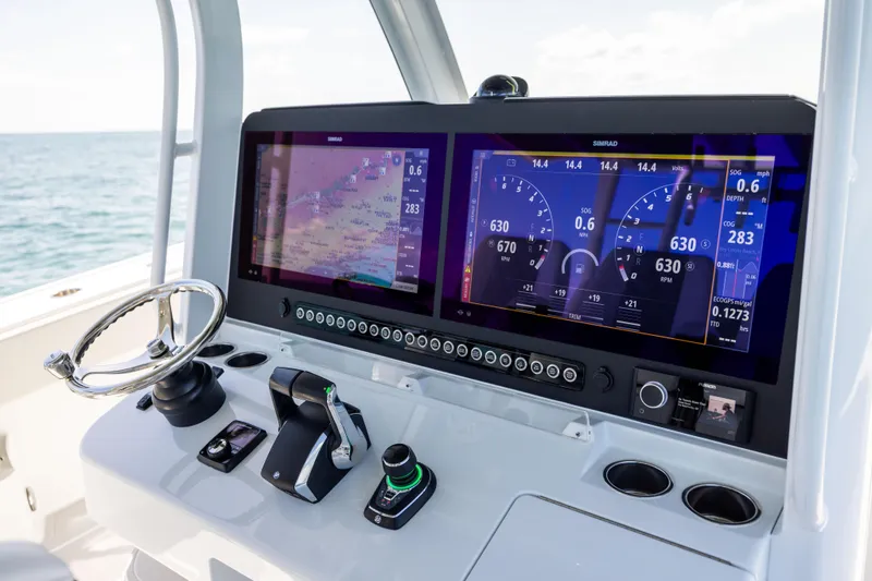 Slide: The Image of Freeman 43 boat dashboard with dual Simrad displays, steering wheel, and controls, 2024 model. - 46