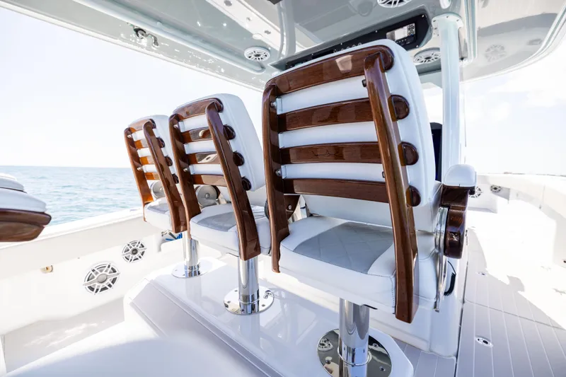 Slide: The Image of Luxury seating on 2024 Freeman 43 boat, featuring elegant wood and white upholstery. - 49