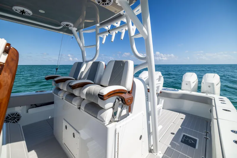 Slide: The Image of 2024 Freeman 43 boat interior with luxurious seating, ocean backdrop, and clear blue sky. - 53