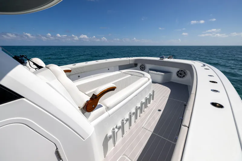 Slide: The Image of 2024 Freeman 43 boat interior with luxurious seating, ocean view, and clear blue sky. - 57