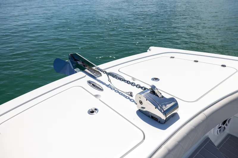 Slide: The Image of 2024 Freeman 43 boat anchor system on deck, floating on calm water. - 61